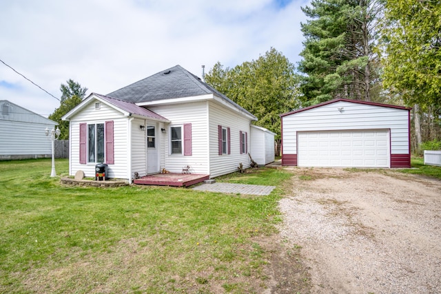 321 N Norman St, Barryton, MI 49305 - view of front of property with an outbuilding, a detached garage, a front lawn, and a wooden deck