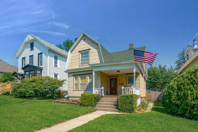 815 Wolcott Ave, Saint Joseph, MI 49085 - view of front of house featuring covered porch, a chimney, and a gambrel roof