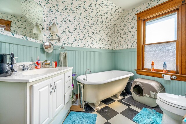 815 Wolcott Ave, Saint Joseph, MI 49085 - full bath featuring wallpapered walls, wainscoting, a freestanding tub, vanity, and tile patterned floors