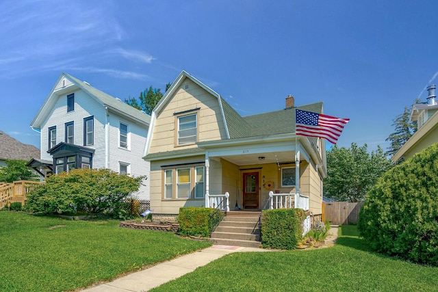 815 Wolcott Ave, Saint Joseph, MI 49085 - view of front of house featuring covered porch, a chimney, and a gambrel roof