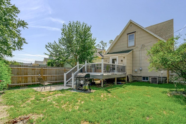 815 Wolcott Ave, Saint Joseph, MI 49085 - rear view of property with a deck, a patio area, roof with shingles, and central air condition unit