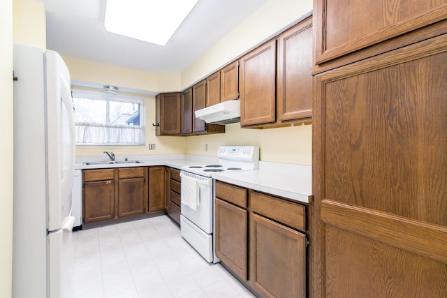 2033 Pauline Ct, Ann Arbor, MI 48103 - kitchen featuring white appliances, light floors, light countertops, under cabinet range hood, and a sink