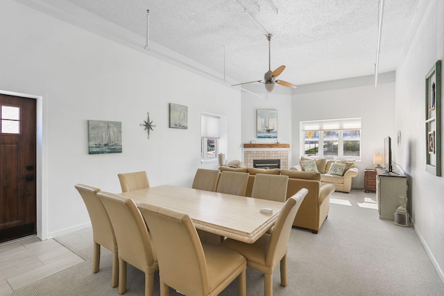 532 Dyckman Ave Unit B1A, South Haven, MI 49090 - dining space featuring attic access, plenty of natural light, a textured ceiling, a glass covered fireplace, and ceiling fan