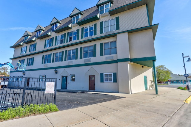 532 Dyckman Ave Unit B1A, South Haven, MI 49090 - townhome / multi-family property with fence, stucco siding, and a shingled roof