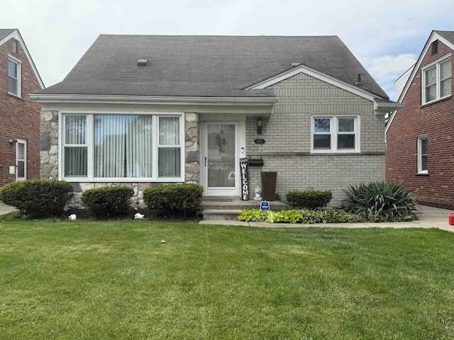9705 Wormer Ave, Redford, MI 48239 - view of front of house with roof with shingles, brick siding, and a front yard