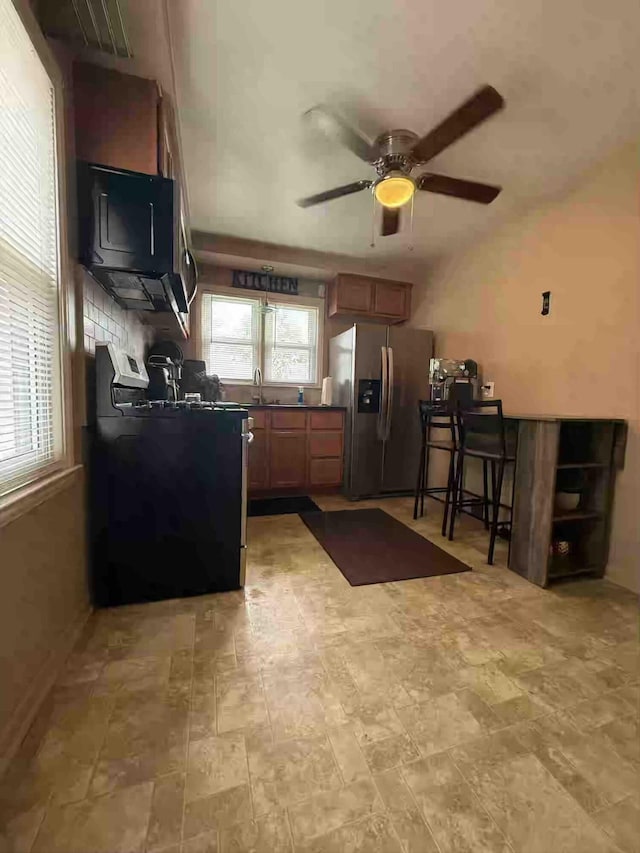 9705 Wormer Ave, Redford, MI 48239 - kitchen featuring a ceiling fan, range, dark countertops, a sink, and stainless steel fridge