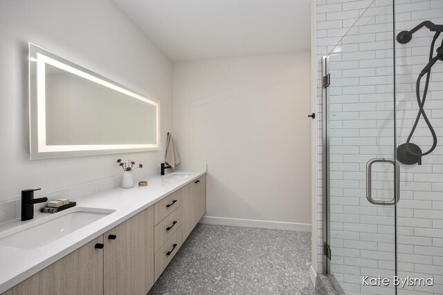 144 Oakes St SW Unit 1905, Grand Rapids, MI 49503 - full bath featuring a sink, baseboards, a shower stall, and double vanity