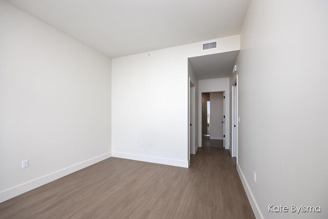 144 Oakes St SW Unit 1905, Grand Rapids, MI 49503 - spare room featuring baseboards, wood finished floors, and visible vents
