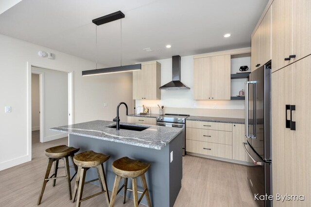144 Oakes St SW Unit 1905, Grand Rapids, MI 49503 - kitchen with wall chimney range hood, appliances with stainless steel finishes, modern cabinets, a sink, and light brown cabinets