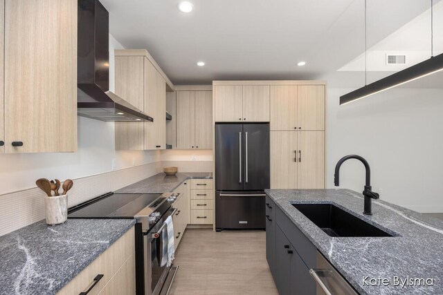 144 Oakes St SW Unit 1905, Grand Rapids, MI 49503 - kitchen featuring a sink, appliances with stainless steel finishes, light brown cabinets, and wall chimney exhaust hood