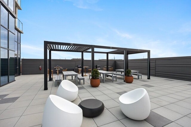 144 Oakes St SW Unit 1905, Grand Rapids, MI 49503 - view of patio / terrace with fence and a pergola