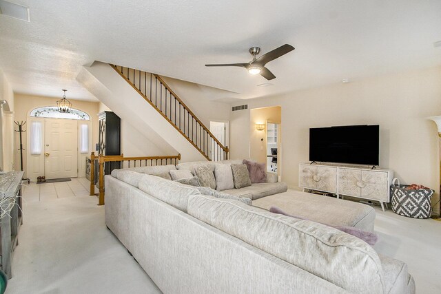 6847 Northstar Ave, Kalamazoo, MI 49009 - living area with light colored carpet, a ceiling fan, and stairs