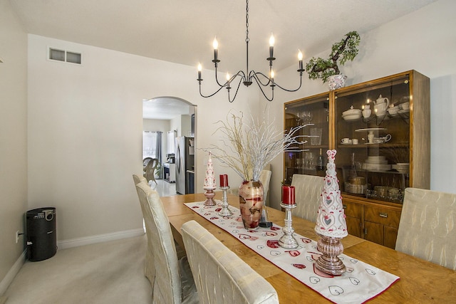 6847 Northstar Ave, Kalamazoo, MI 49009 - carpeted dining room featuring arched walkways, a chandelier, and baseboards