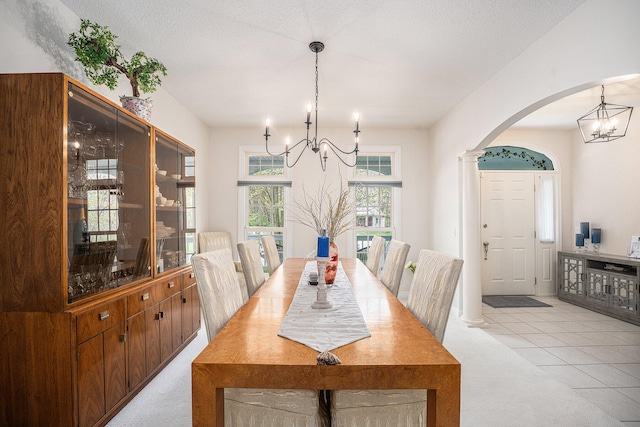 6847 Northstar Ave, Kalamazoo, MI 49009 - dining area featuring a chandelier, arched walkways, and light colored carpet