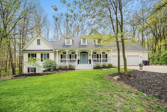 6847 Northstar Ave, Kalamazoo, MI 49009 - view of front of house with covered porch, driveway, a front lawn, and a garage