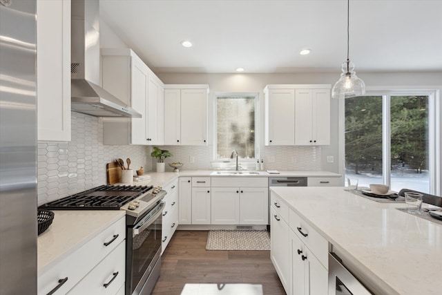 6602 E E Ave, Richland, MI 49083 - kitchen with gas range, a sink, wall chimney range hood, dark wood finished floors, and white cabinets