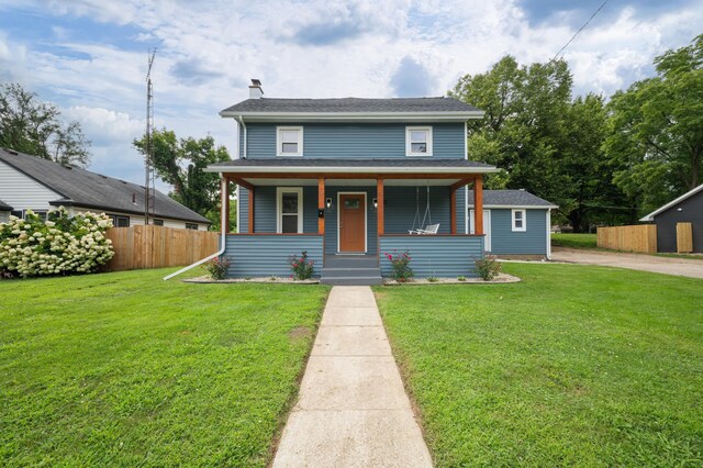 123 N 2nd St, Cassopolis, MI 49031 - bungalow-style house featuring a chimney, a front yard, a porch, and fence