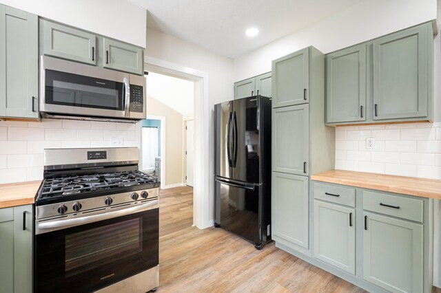 123 N 2nd St, Cassopolis, MI 49031 - kitchen with wood counters, light wood-style flooring, green cabinets, and appliances with stainless steel finishes