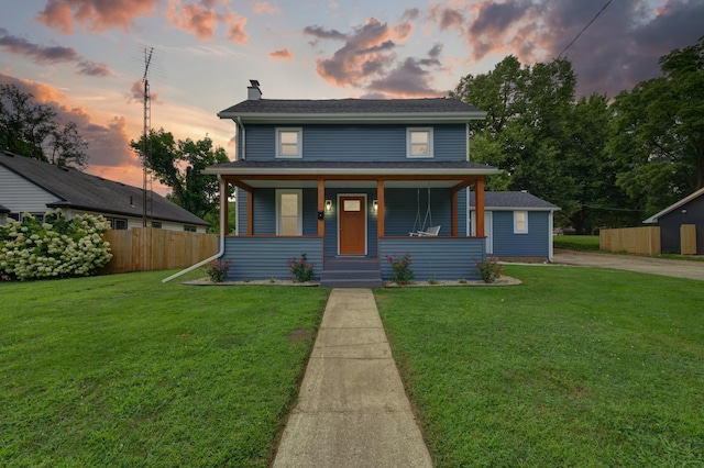 123 N 2nd St, Cassopolis, MI 49031 - view of front of house with a front lawn, a chimney, covered porch, and fence