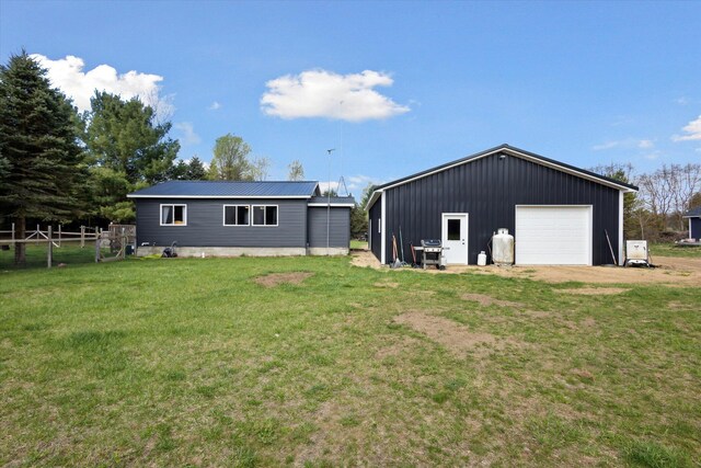 1366 Grow Rd NW, Stanton, MI 48888 - rear view of house with a garage, an outdoor structure, and driveway