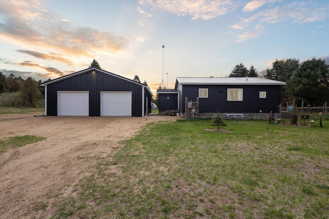1366 Grow Rd NW, Stanton, MI 48888 - view of front facade with an outbuilding, a garage, a lawn, and metal roof