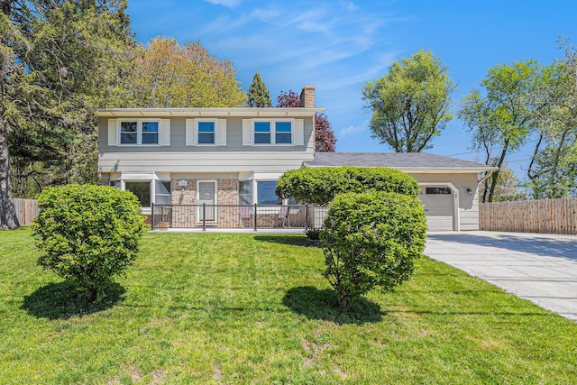 105 N Dr E, Marshall, MI 49068 - view of front of home with an attached garage, concrete driveway, a chimney, and brick siding
