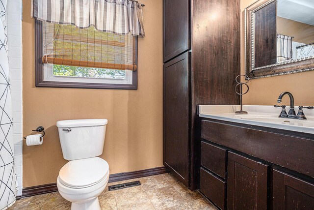 105 N Dr E, Marshall, MI 49068 - bathroom featuring baseboards, toilet, and vanity