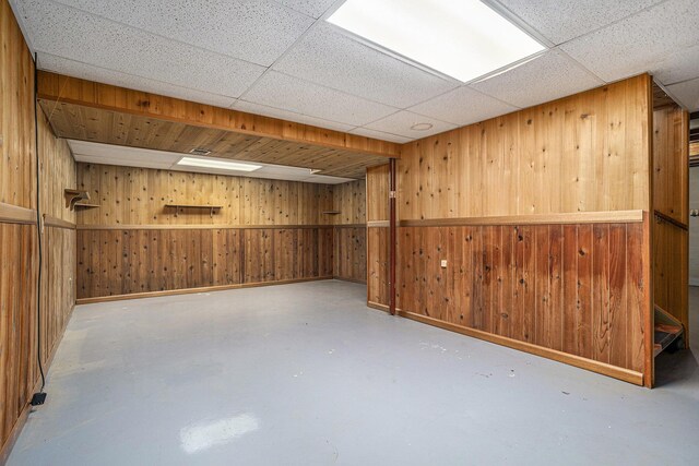 105 N Dr E, Marshall, MI 49068 - finished basement with wood walls, baseboards, and a drop ceiling