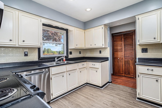 105 N Dr E, Marshall, MI 49068 - kitchen featuring a sink, dark countertops, light wood finished floors, decorative backsplash, and recessed lighting