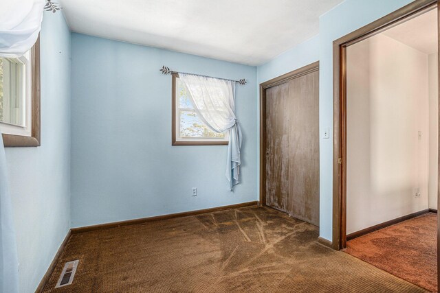 105 N Dr E, Marshall, MI 49068 - unfurnished bedroom featuring carpet flooring, a closet, and baseboards