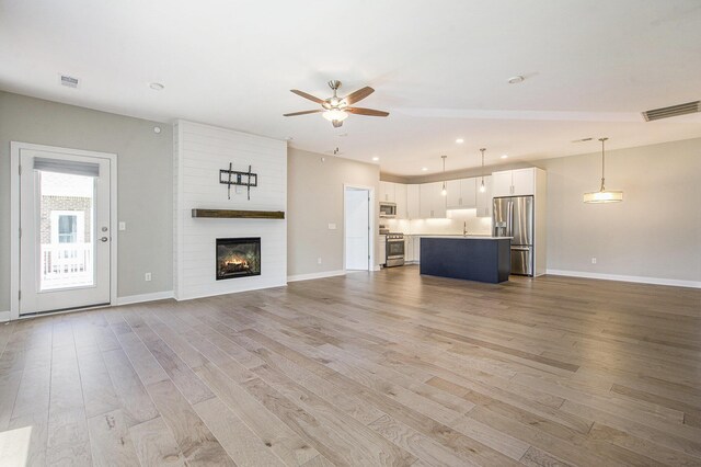603 Woodland, Dexter, MI 48130 - unfurnished living room with ceiling fan, light wood-type flooring, baseboards, and recessed lighting