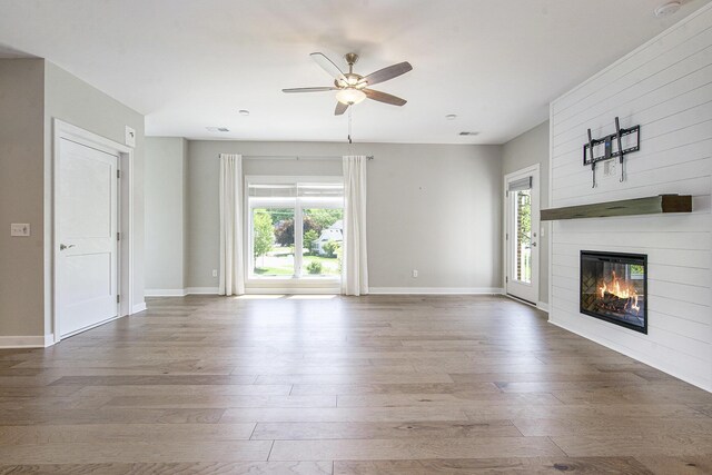 603 Woodland, Dexter, MI 48130 - unfurnished living room with hardwood / wood-style floors, a ceiling fan, and healthy amount of natural light
