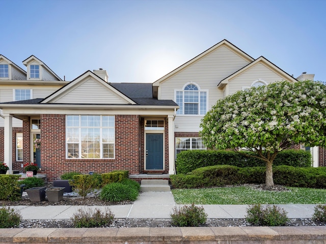 8204 Alexa Dr, Walled Lake, MI 48390 - view of front of home featuring brick siding, a chimney, and cooling unit