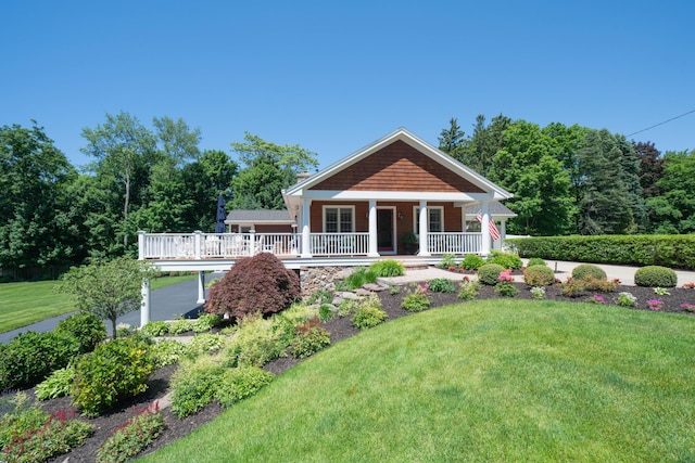 view of front of house with a front yard and covered porch