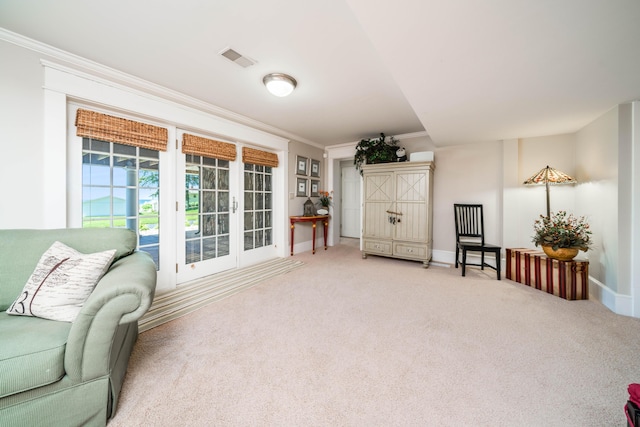 sitting room with crown molding, carpet flooring, and baseboards