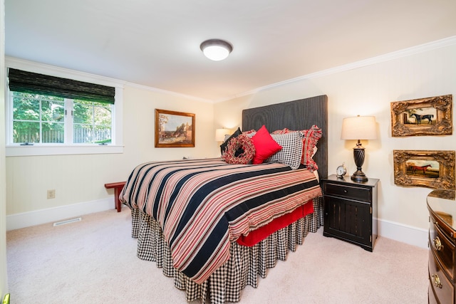bedroom with carpet flooring, ornamental molding, and baseboards