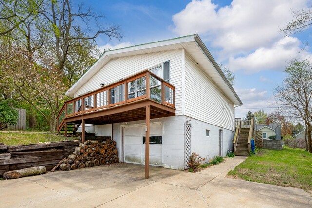 3742 School St, Bridgman, MI 49106 - view of side of property featuring concrete driveway, stairway, a wooden deck, and a garage