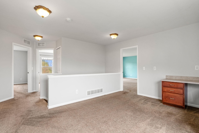 empty room with dark carpet, baseboards, and a smoke detector
