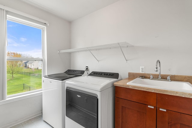 laundry room featuring washer and dryer, baseboards, and cabinet space