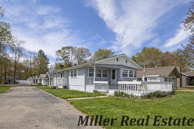 11811 Marsh Rd Unit 10, Shelbyville, MI 49344 - view of front of property with a front lawn, covered porch, and asphalt driveway