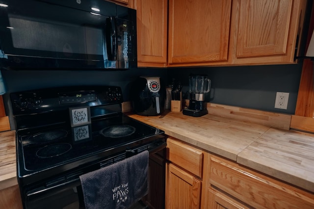 kitchen with wood counters and black appliances
