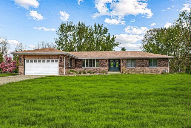 5407 Browntown Rd, Sawyer, MI 49125 - ranch-style home featuring a garage, concrete driveway, a front yard, and french doors