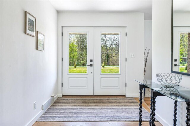 5407 Browntown Rd, Sawyer, MI 49125 - doorway featuring french doors, wood finished floors, and baseboards