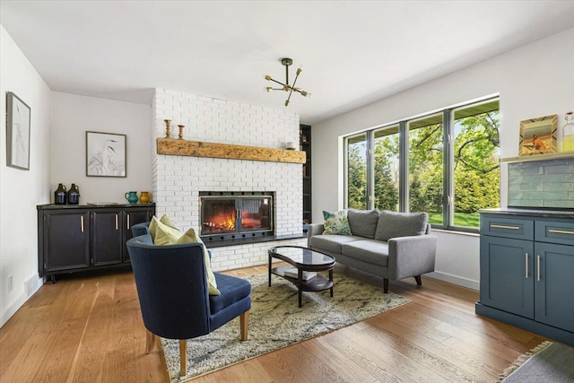 5407 Browntown Rd, Sawyer, MI 49125 - living room featuring light wood finished floors, baseboards, and a brick fireplace