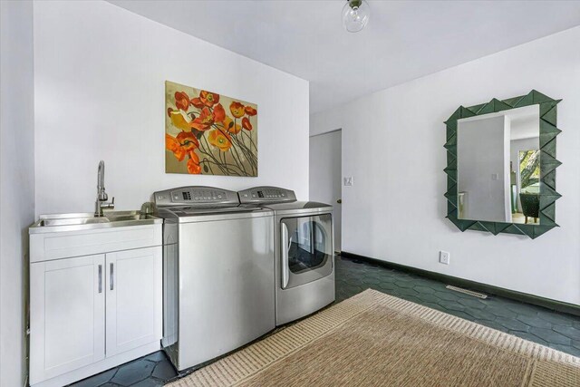 5407 Browntown Rd, Sawyer, MI 49125 - clothes washing area featuring washing machine and clothes dryer, baseboards, and cabinet space