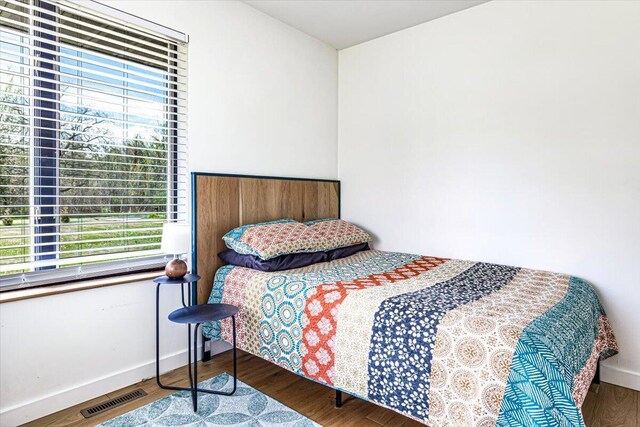 5407 Browntown Rd, Sawyer, MI 49125 - bedroom with multiple windows, wood finished floors, and baseboards