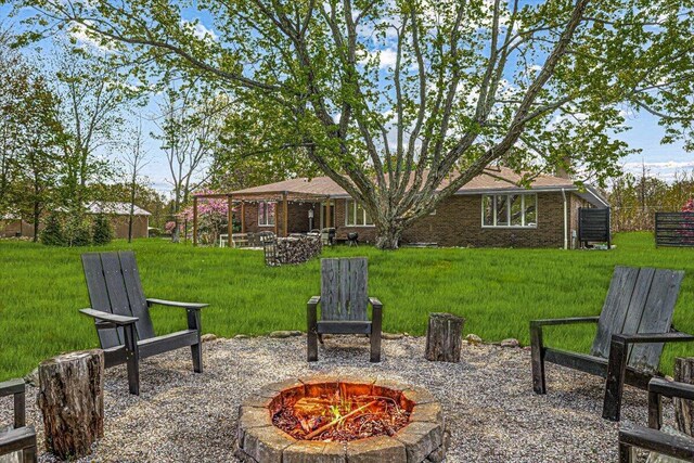 5407 Browntown Rd, Sawyer, MI 49125 - view of green lawn with an outdoor fire pit and a patio