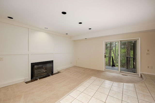 3949 Waldenwood Dr, Ann Arbor, MI 48105 - unfurnished living room featuring a fireplace with flush hearth, light colored carpet, recessed lighting, and light tile patterned flooring