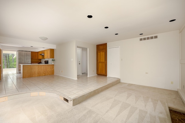 3949 Waldenwood Dr, Ann Arbor, MI 48105 - unfurnished living room with light tile patterned floors and light carpet