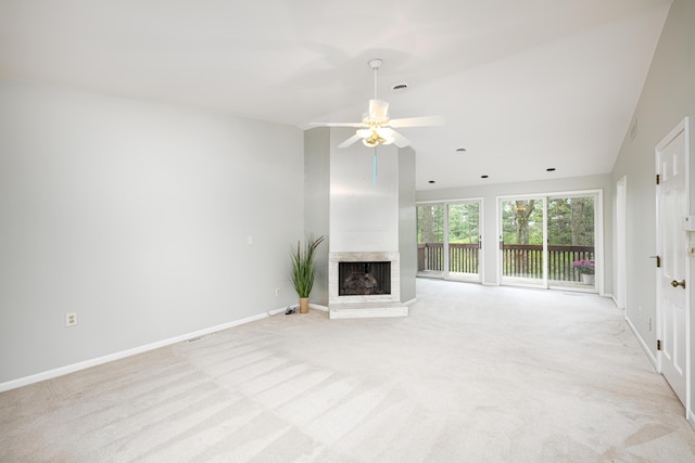 3949 Waldenwood Dr, Ann Arbor, MI 48105 - unfurnished living room with lofted ceiling, light carpet, a fireplace with raised hearth, a ceiling fan, and baseboards
